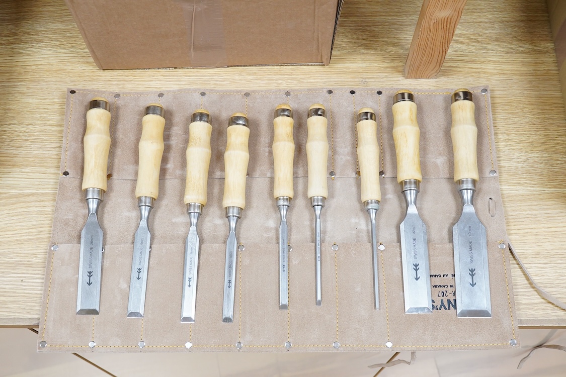 Three sets of woodworking chisels, including a cased six piece set by Seit, Germany, a nine piece set by Herschel, Germany, in a leather roll and a Swiss made nine piece set also in a leather roll